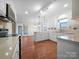 Kitchen with white cabinets, updated appliances, and hardwood floors at 500 Kirby Ln, Matthews, NC 28104