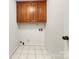 Laundry room with wood cabinets and tile floor at 500 Kirby Ln, Matthews, NC 28104