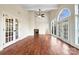 Spacious living area with hardwood floors, fireplace, and sunroom access at 500 Kirby Ln, Matthews, NC 28104
