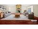 Virtually staged living room featuring stone fireplace and hardwood floors at 500 Kirby Ln, Matthews, NC 28104