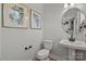 Powder room with pedestal sink and decorative art at 5029 Westmead Ln, Charlotte, NC 28262