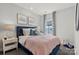 Bedroom with a pink comforter and blue headboard at 5029 Westmead Ln, Charlotte, NC 28262