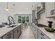 Modern kitchen with gray cabinets, quartz countertops, and stainless steel appliances at 5029 Westmead Ln, Charlotte, NC 28262