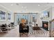 Spacious living room with fireplace, and access to backyard at 5029 Westmead Ln, Charlotte, NC 28262