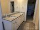 Elegant bathroom with double sinks and walk-in closet access at 5860 Clan Maclaine Dr, Charlotte, NC 28278
