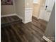 Entryway with dark wood-look flooring and white wainscoting at 5860 Clan Maclaine Dr, Charlotte, NC 28278