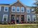 Two-story home with stone and gray siding at 5860 Clan Maclaine Dr, Charlotte, NC 28278