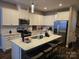 Modern kitchen with white cabinets, granite countertops, and stainless steel appliances at 5860 Clan Maclaine Dr, Charlotte, NC 28278