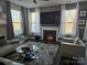 Spacious living room with fireplace and large TV at 5860 Clan Maclaine Dr, Charlotte, NC 28278