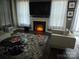 Living room featuring a fireplace, large TV, and comfy seating at 5860 Clan Maclaine Dr, Charlotte, NC 28278