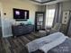 Main bedroom with large TV, comfortable seating, and ample closet space at 5860 Clan Maclaine Dr, Charlotte, NC 28278