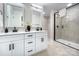 Double vanity bathroom with white cabinets and frameless shower at 710 N Cedar St, Lincolnton, NC 28092