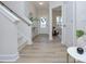 Bright and airy entryway with light wood floors and staircase at 710 N Cedar St, Lincolnton, NC 28092