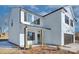 White two-story house with dark brown garage door and shutters at 710 N Cedar St, Lincolnton, NC 28092