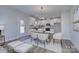 Modern kitchen with white cabinets and glass-top dining table at 710 N Cedar St, Lincolnton, NC 28092