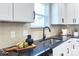 Kitchen detail showing granite countertop, sink, and beige tile backsplash at 710 N Cedar St, Lincolnton, NC 28092