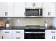 Stainless steel appliances and white cabinets in a modern kitchen at 710 N Cedar St, Lincolnton, NC 28092