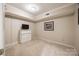 Small bedroom with a dresser and wall-mounted TV. Neutral color palette at 78 Honeysuckle Woods, Lake Wylie, SC 29710