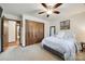 Cozy bedroom with wood closet doors and ceiling fan at 78 Honeysuckle Woods, Lake Wylie, SC 29710