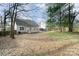 Backyard with a wooden deck and fence, mature landscaping and tree coverage at 8624 Woodcock Ln, Charlotte, NC 28216