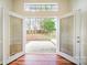 View of backyard through open glass doors to patio and fenced yard at 8624 Woodcock Ln, Charlotte, NC 28216