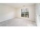 Bright bedroom with a large window, neutral walls, and plush carpeting at 8624 Woodcock Ln, Charlotte, NC 28216