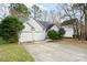 Home exterior with two-car garage and ample parking on concrete driveway at 8624 Woodcock Ln, Charlotte, NC 28216