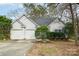 Charming single-story home featuring a two-car garage, well-maintained lawn and mature trees at 8624 Woodcock Ln, Charlotte, NC 28216