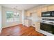 Eat-in kitchen with hardwood floors, wooden cabinets, and a window overlooking the backyard at 8624 Woodcock Ln, Charlotte, NC 28216