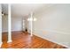 Open living room features neutral walls, elegant trim, hardwood floors, and a fireplace at 8624 Woodcock Ln, Charlotte, NC 28216