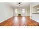 Cozy living room featuring laminate flooring, fireplace, and architectural columns for a warm and inviting atmosphere at 8624 Woodcock Ln, Charlotte, NC 28216