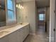 Double vanity bathroom with gray tile and a large mirror at 9625 Liberty Hill Dr, Mint Hill, NC 28227