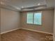 Spacious bedroom with wood-look floors and two windows at 9625 Liberty Hill Dr, Mint Hill, NC 28227