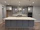 Modern kitchen with gray cabinets, white countertops, and a large island at 9625 Liberty Hill Dr, Mint Hill, NC 28227