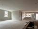 Spacious living room with neutral walls and large windows at 9625 Liberty Hill Dr, Mint Hill, NC 28227