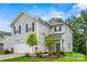Two-story house with gray siding, white garage door, and landscaping at 10006 Travis Floyd Ln # 002, Charlotte, NC 28214