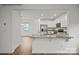 Modern kitchen with white cabinets, granite counters and island at 10006 Travis Floyd Ln # 002, Charlotte, NC 28214