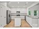 Modern kitchen with white cabinets, granite counters and island at 10006 Travis Floyd Ln # 002, Charlotte, NC 28214