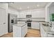 Modern kitchen with white cabinets, granite counters and island at 10006 Travis Floyd Ln # 002, Charlotte, NC 28214
