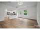 Spacious living room with hardwood floors and kitchen access at 10006 Travis Floyd Ln # 002, Charlotte, NC 28214