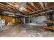 Unfinished basement with exposed beams, concrete floor, and ample storage space at 107 E Boyd St, Maiden, NC 28650