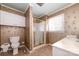 Bathroom features a shower, toilet, double vanity, and floral wallpaper at 107 E Boyd St, Maiden, NC 28650