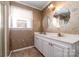 Bathroom with double vanity, floral wallpaper, and shower at 107 E Boyd St, Maiden, NC 28650
