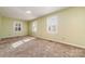 Well-lit bedroom with neutral walls and carpet flooring at 107 E Boyd St, Maiden, NC 28650