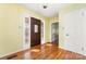 Bright entryway with hardwood floors and a wood door at 107 E Boyd St, Maiden, NC 28650