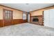 Gathering room with brick fireplace, built-in shelving, and wood paneling at 107 E Boyd St, Maiden, NC 28650