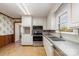 Kitchen features white cabinets, granite countertops, and stainless steel appliances at 107 E Boyd St, Maiden, NC 28650