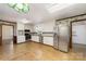 Spacious kitchen with white cabinets, stainless steel appliances, and cork flooring at 107 E Boyd St, Maiden, NC 28650