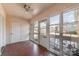 Bright sunroom with tiled floor, ceiling fan, and multiple windows at 107 E Boyd St, Maiden, NC 28650