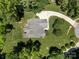 Aerial view of a home with a long driveway and well-manicured lawn surrounded by trees at 254 Streamside Pl, Mooresville, NC 28115
